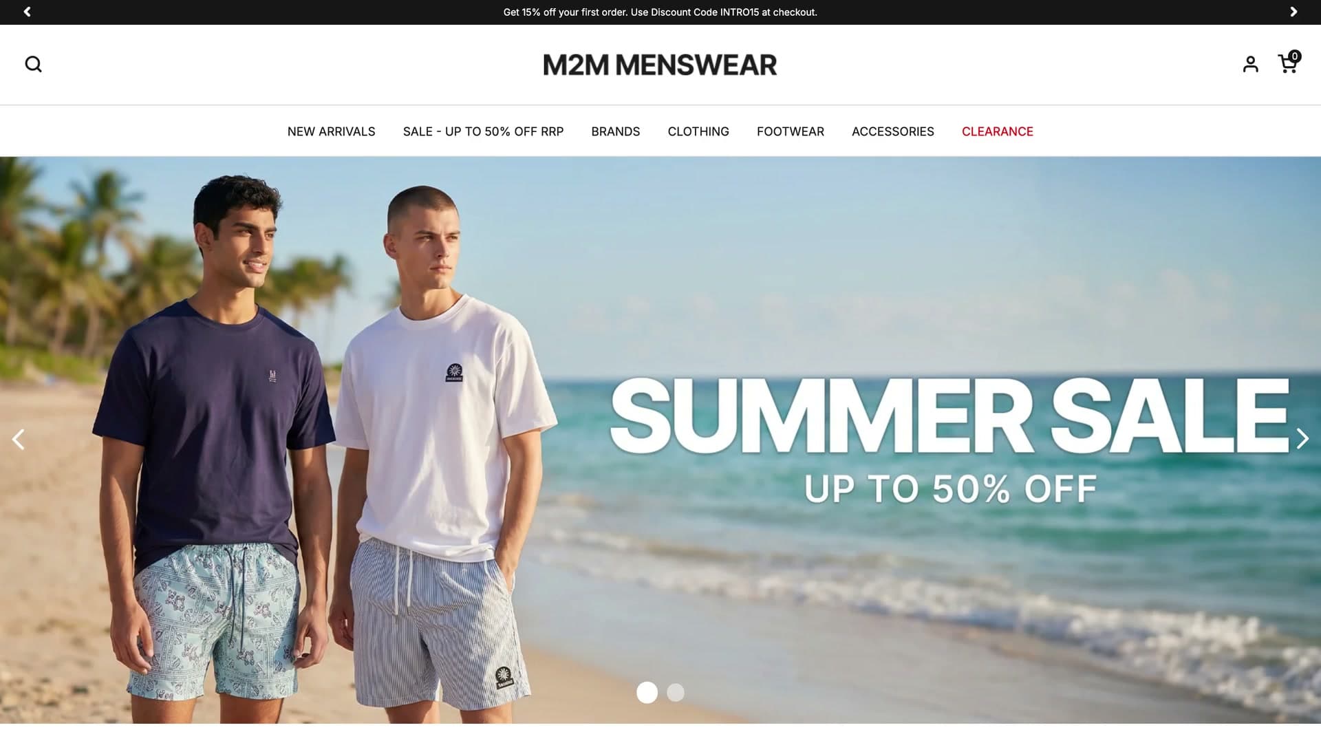M2M Menswear homepage with a Summer Sale up to 50% off hero of two models on a beach