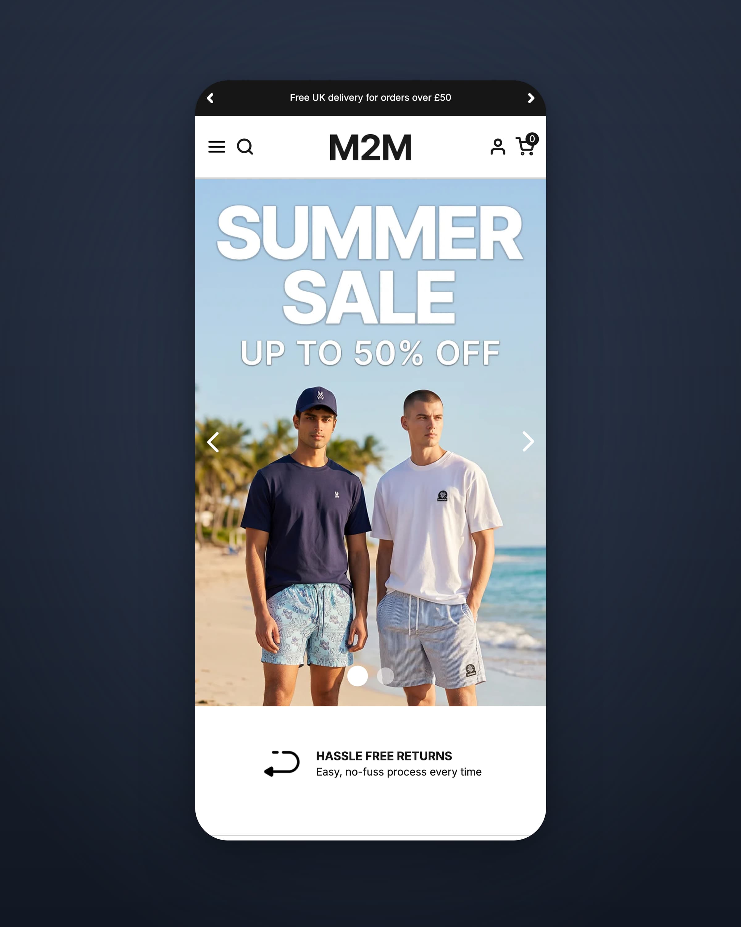 M2M Menswear homepage on a phone, with a Summer Sale up to 50% off hero showing two models on a beach